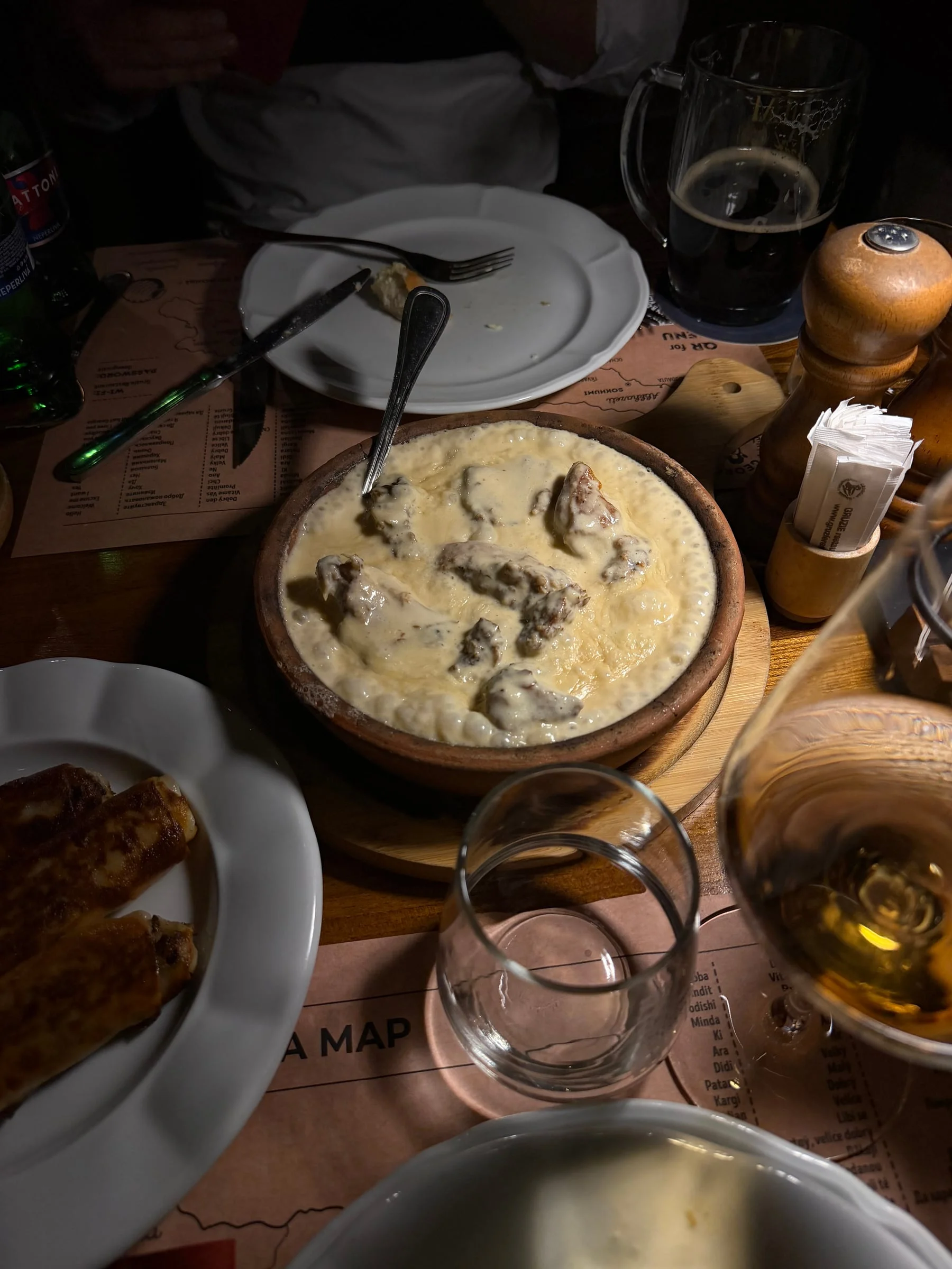 Chunks of meat in bubbling melted cheese, served in a clay ketsi dish